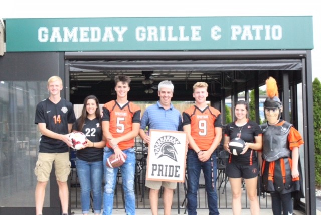 people wearing jerseys and holding sign